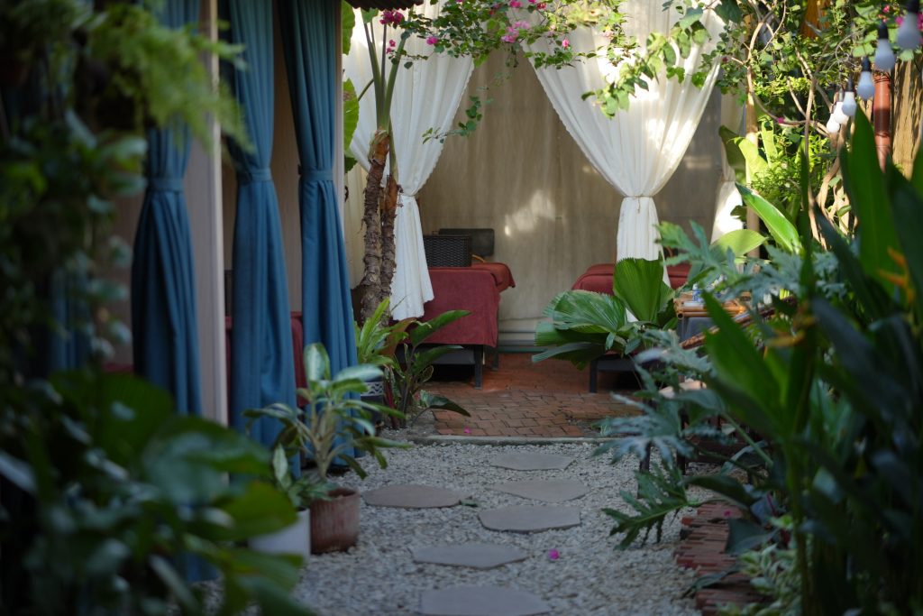 Treatment room with blue curtains at Agarwood Spa Hoi An